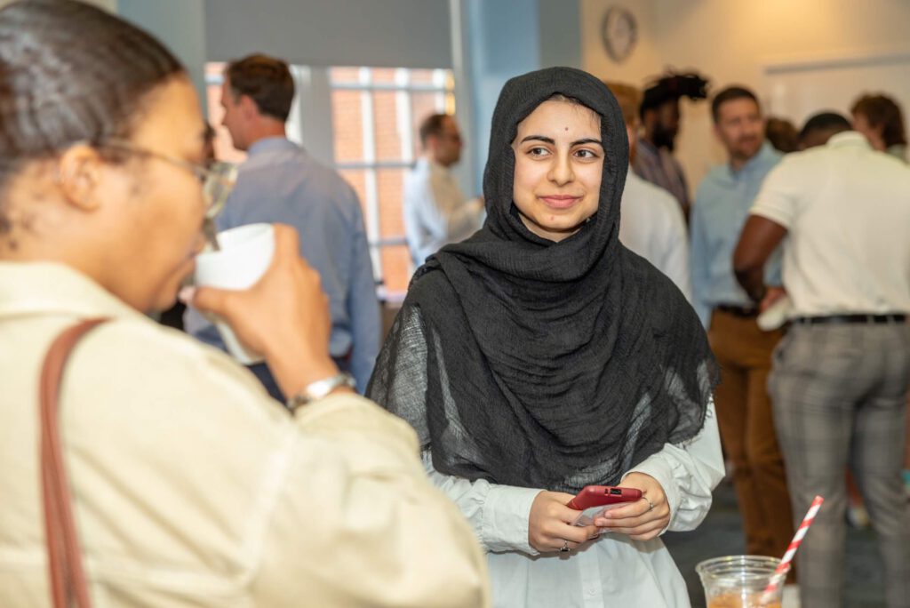 Mindful Education apprentice smiling at another colleague.