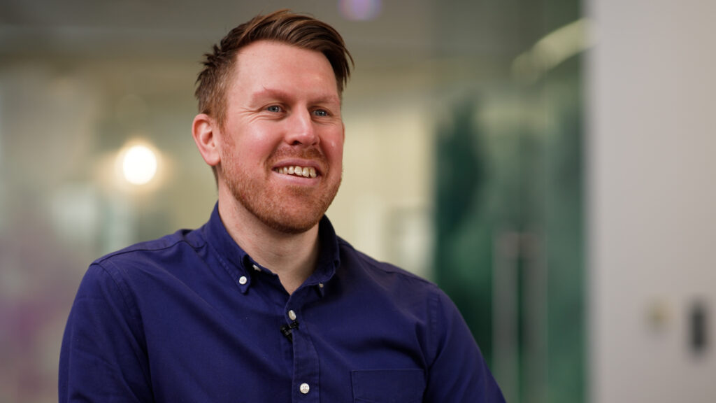 An image of a Mindful Education accounting apprentice sat down and smiling.