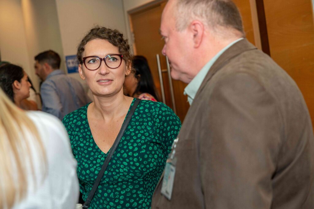 Two Mindful Education employees engaged in a conversation.