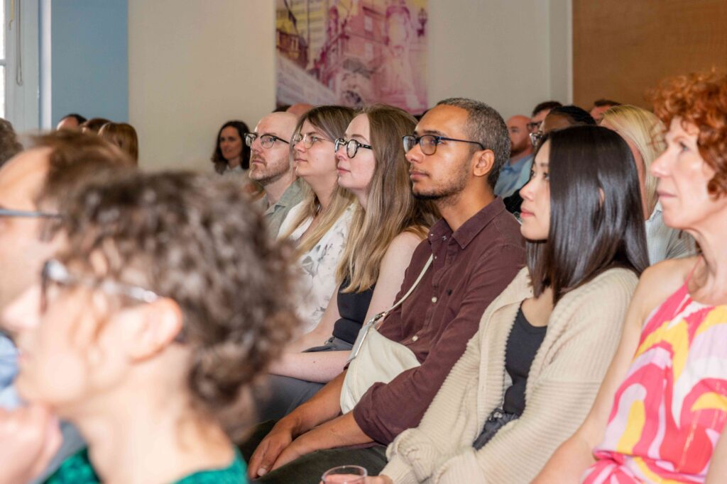 Image of Mindful Education employees sat down and listening to another colleague present.
