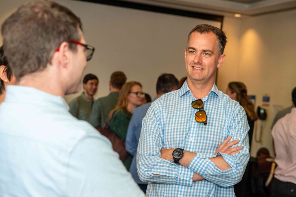 Image of two Mindful Education employees smiling and chatting to one another.