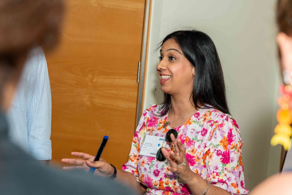 A Mindful Education employee smiling at other colleagues.