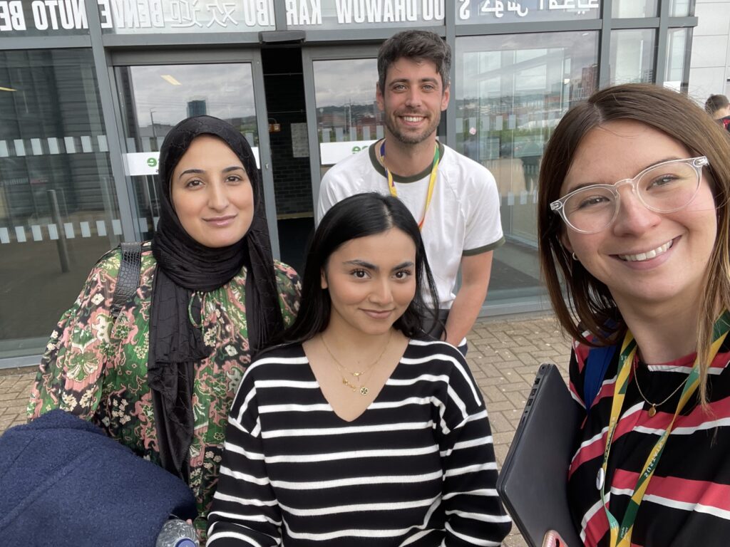 Two Mindful Education employees smiling and taking a selfie with two marketing individuals from Kidderminster College.
