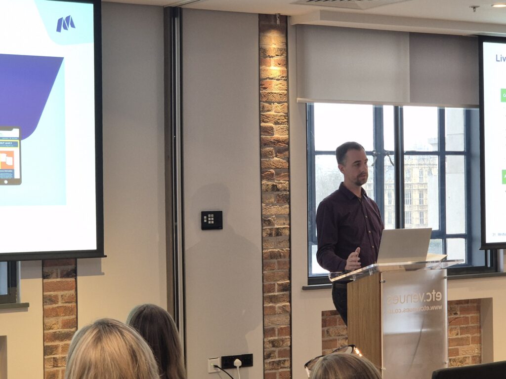 Mindful Education's Head of Digital presenting to fellow colleagues during the company's Winter Conference about updates to our Virtual Learning Environment.