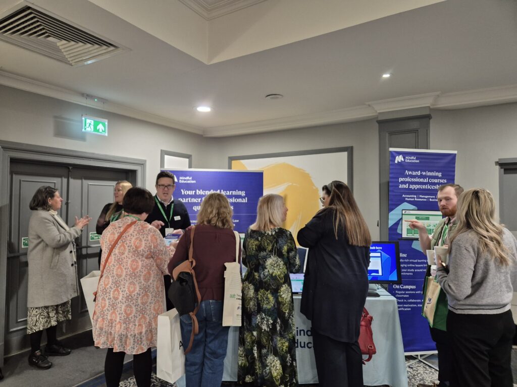 Established people in the accounting industry gathering around Mindful Education employees to learn more about their blended learning courses.