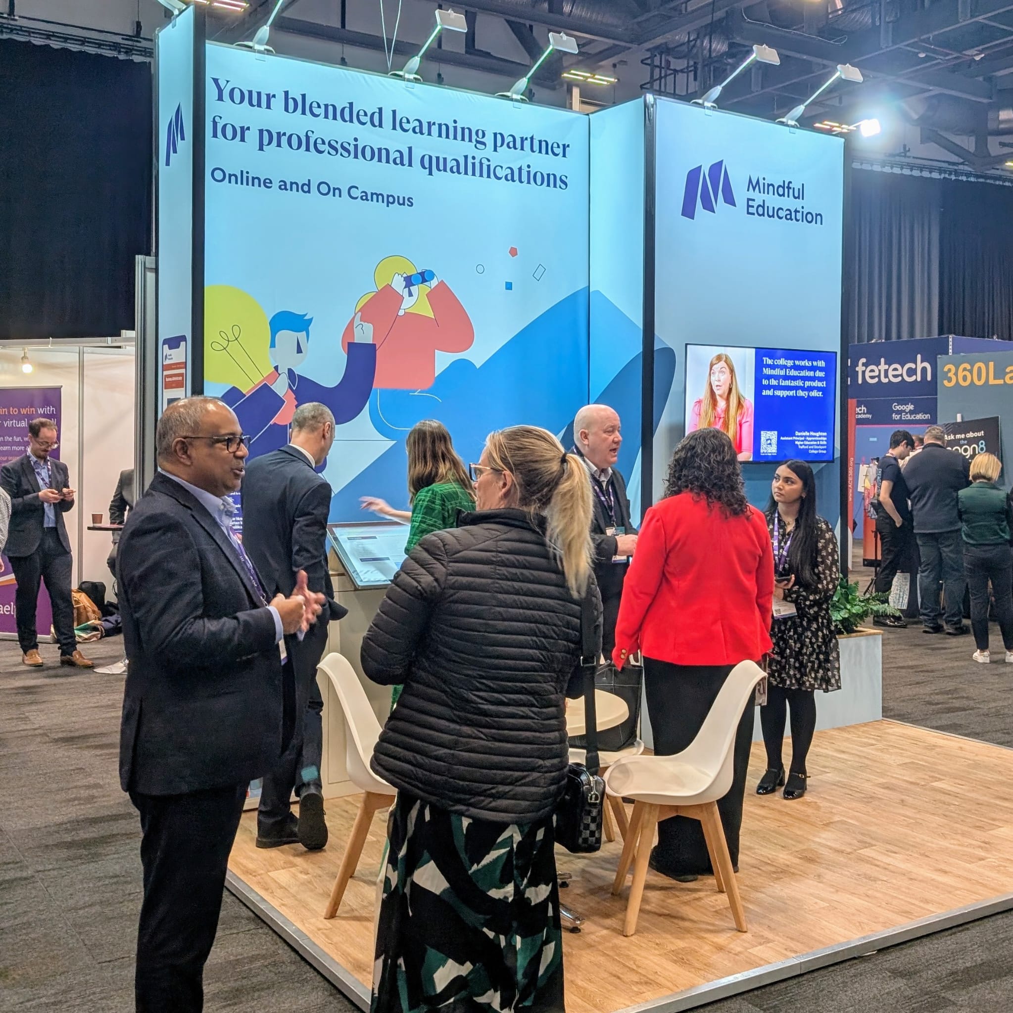 Professionals within the further education sector conversing with one another at an industry event.