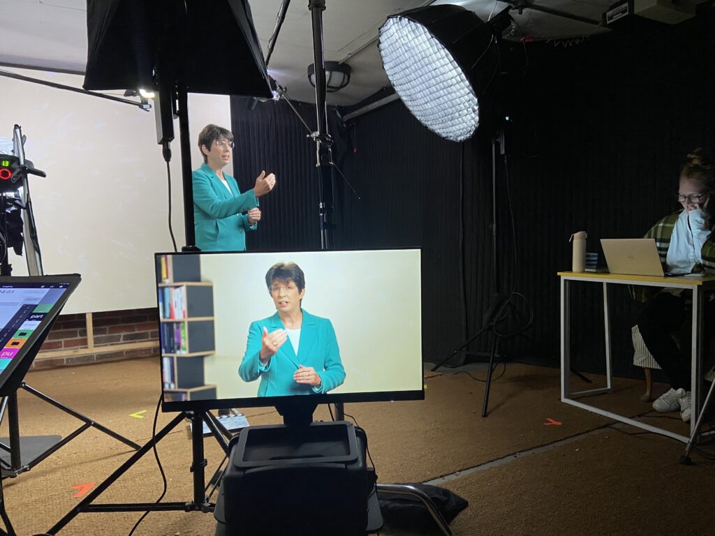 An image of a woman in a studio, filming for one of Mindful Education’s professional courses.
