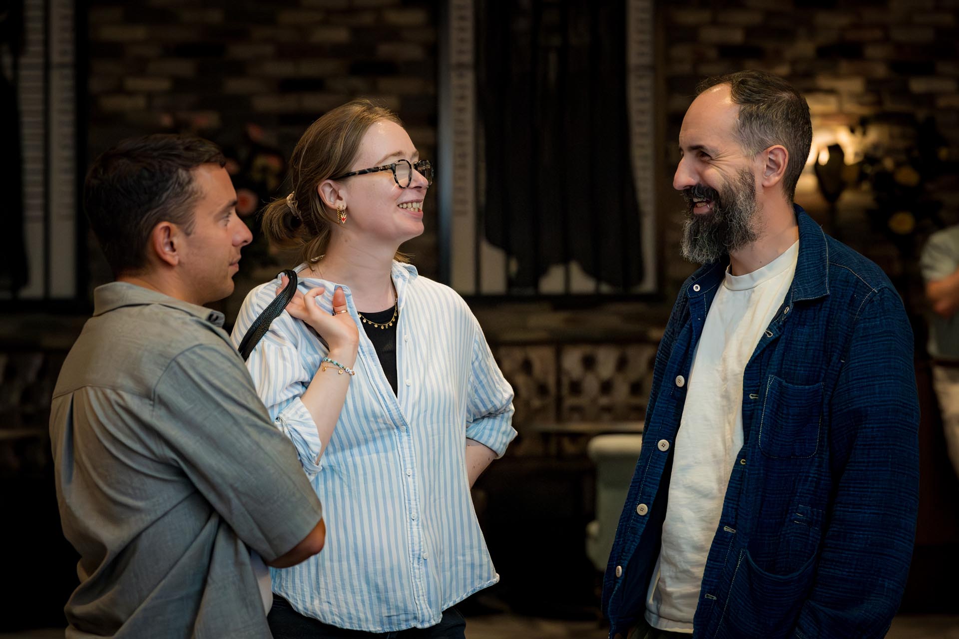 Three Mindful Education employees socialising at a company conference.